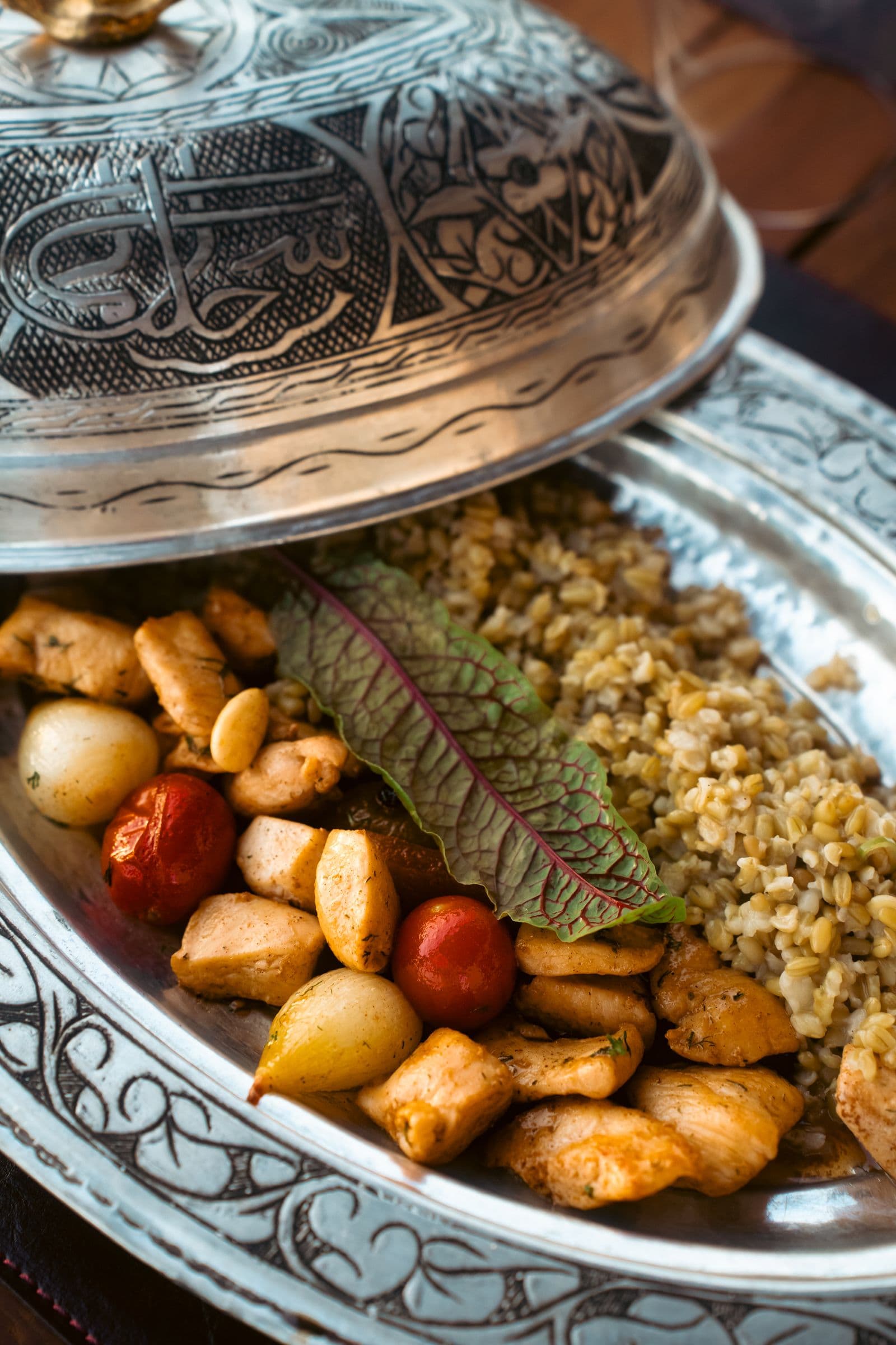 Chicken, potatoes, and vegetables served with fresh herbs