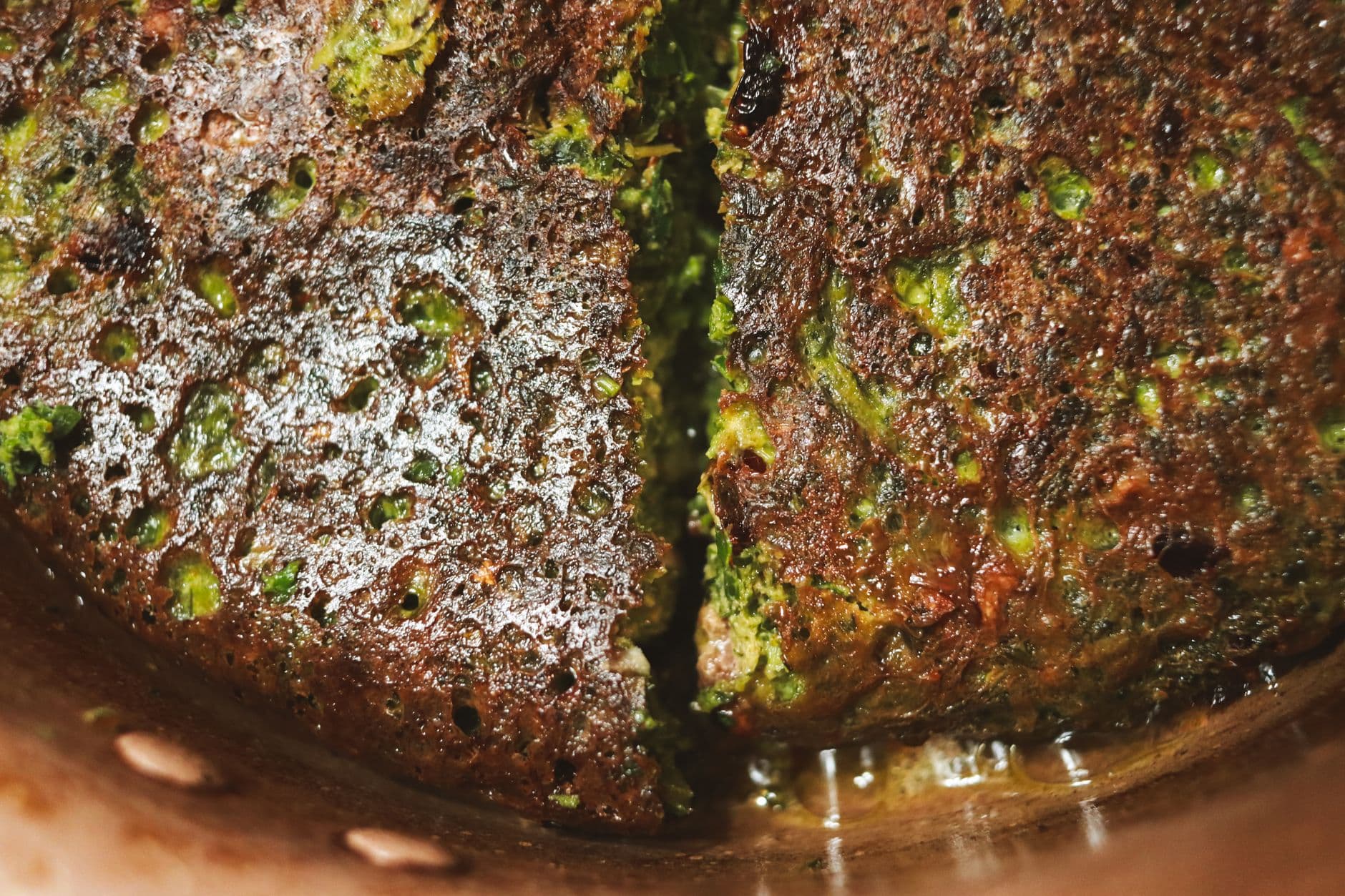 Zucchini fritters with yogurt and red pepper on a white platter