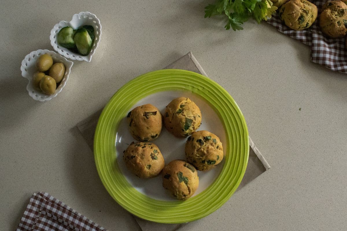 Savory herb muffins with olives and cucumber; illustrative plating, not this measured oat-and-spinach recipe