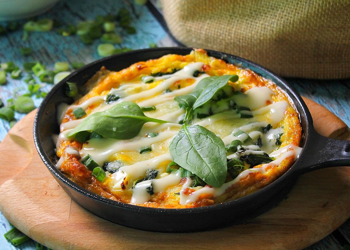 Egg skillet with greens, as a serving illustration