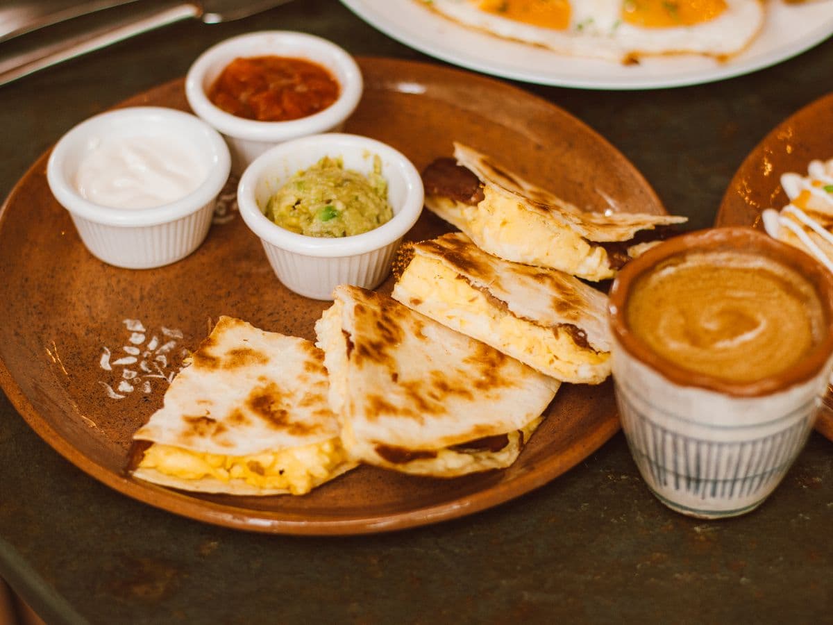 Toasted quesadilla pieces with sauces, as a serving illustration