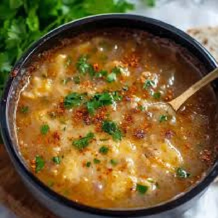 Chorba Hamra bel Frik (Algerian Lamb, Tomato, and Freekeh Soup) prepared and served as the finished dish